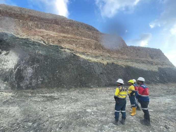 BMP Drill personnel inspecting an open pit mining area
